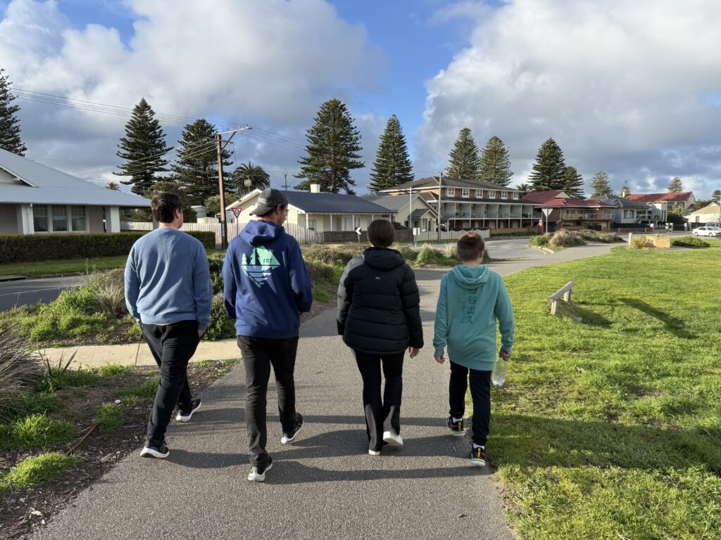 Group of participants walking together on the foreshore