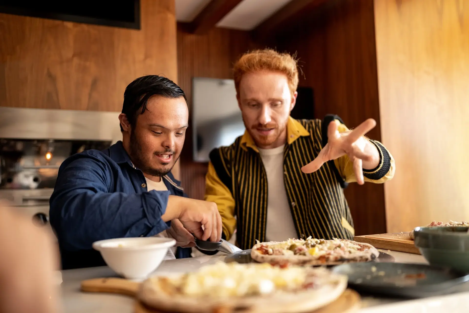 Two people cooking a meal together