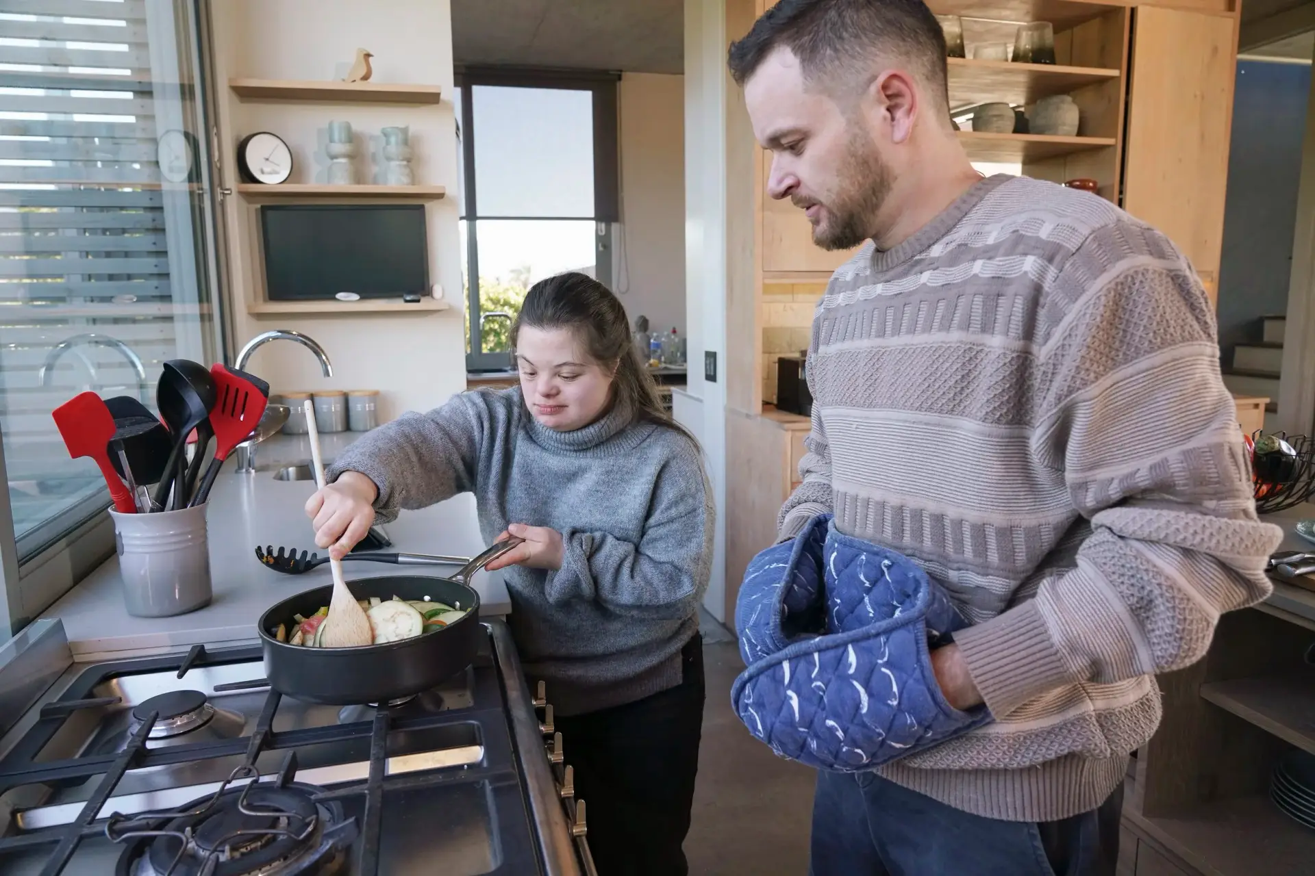 Support worker cooking with a participant at home